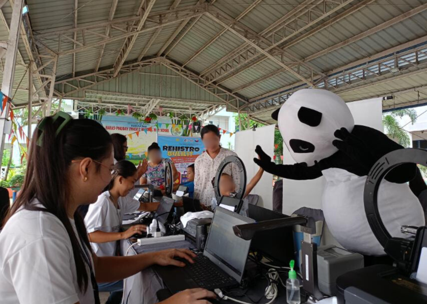 Mascot greeting a kid registering